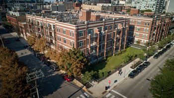 A red car is parked on the side of a street.